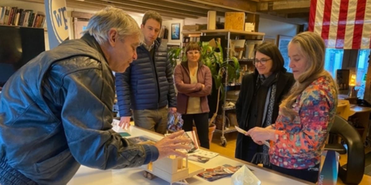 Representative Becca Balint looks at models of a WheelPad prototype while talking with Joseph Cincotta and Julie Linberger, the founders of WheelPad.